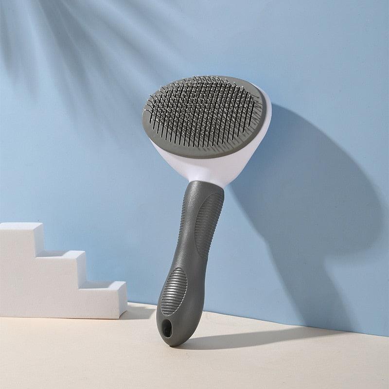 Gray pet grooming brush with oval pin brush head and textured non-slip handle