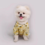 Bee-print pet pajama set on small dog, yellow pattern with button front