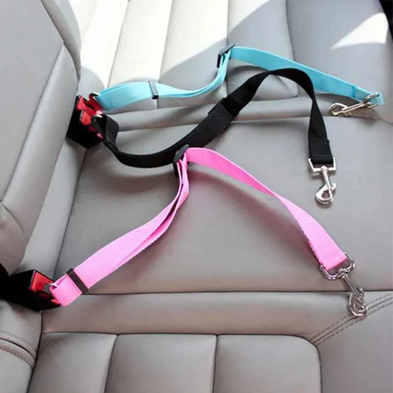 Pet car seat belt harness with pink and black straps, metal seat-belt clip and leash ring
