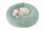 Plush round donut pet bed, mint green shag cushion with sleeping cat