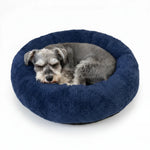 Plush round donut pet bed, navy shag cushion with sleeping dog