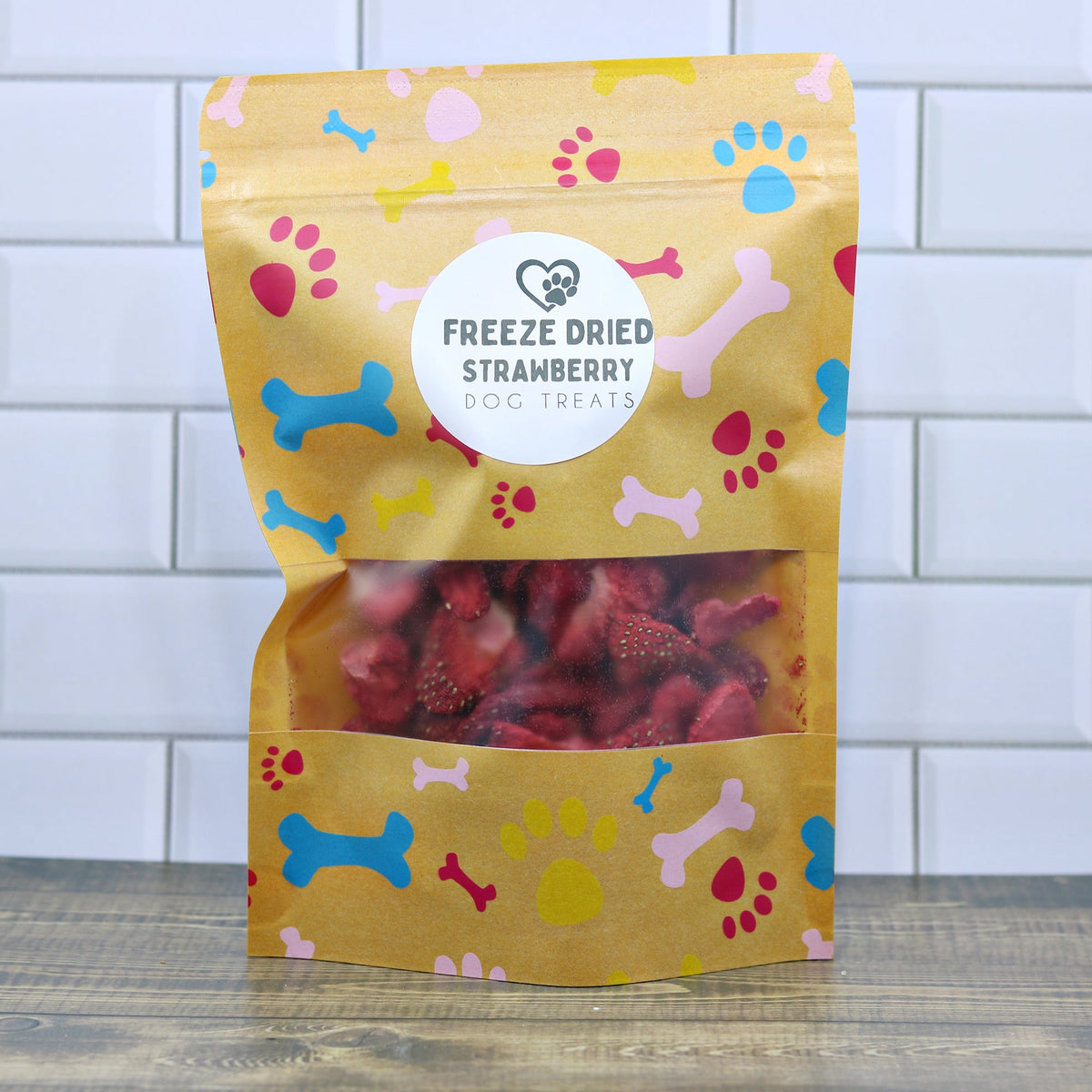 Freeze-dried strawberry dog treats in gold pouch bag with paw print pattern