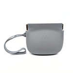 Gray silicone treat training pouch with wrist strap and metal snap clasp closure.