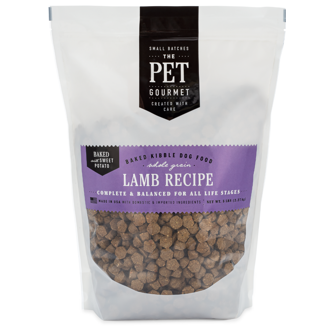 Lamb recipe dog food bag with purple label and visible baked kibble pieces