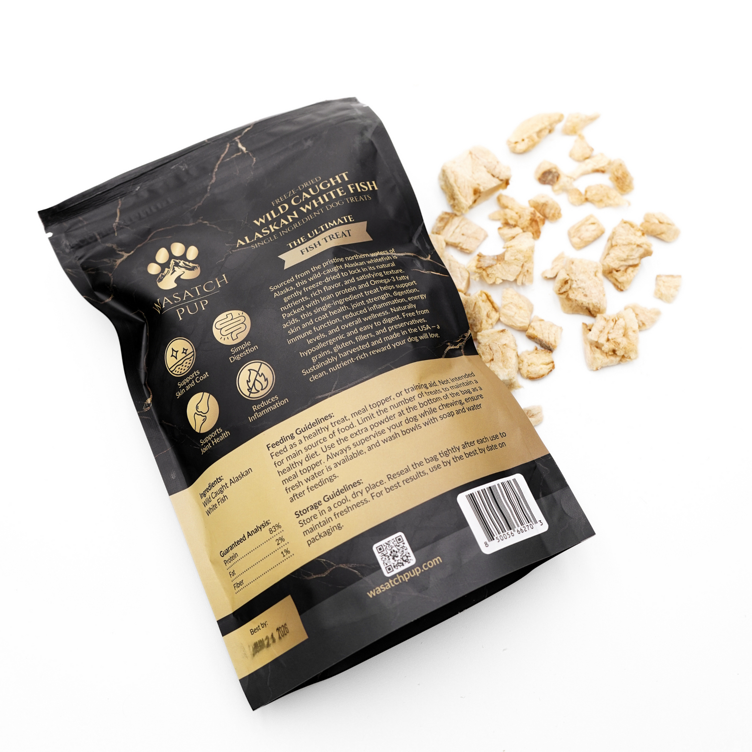 Freeze-dried fish treat pouch lying down with scattered fish chunks