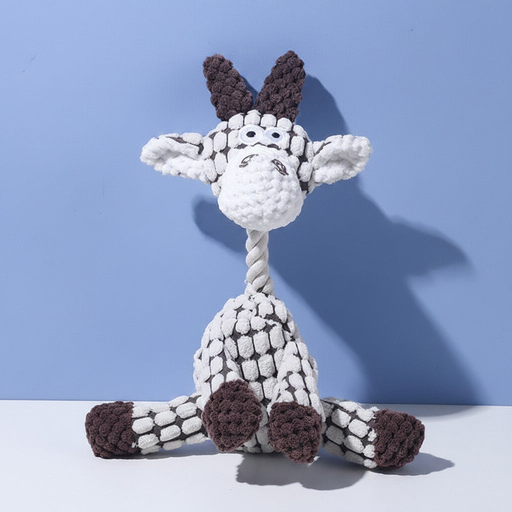 Plush squeaky animal dog toy in white with dark brown and gray spotted pattern.