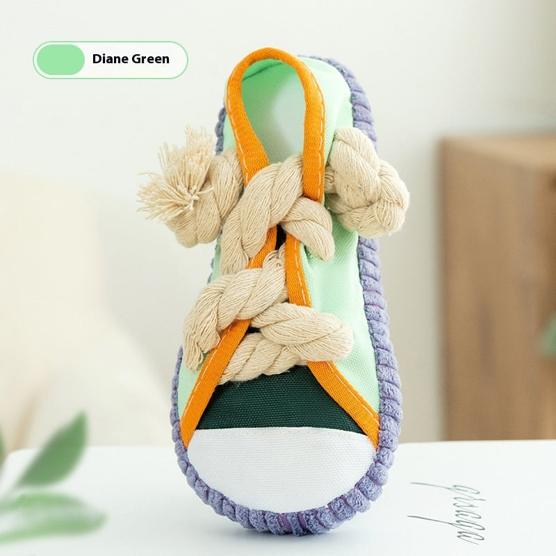 Diane Green squeaky plush shoe dog toy with green base, orange straps, and rope knots