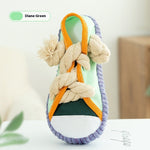 Diane Green squeaky plush shoe dog toy with green base, orange straps, and rope knots