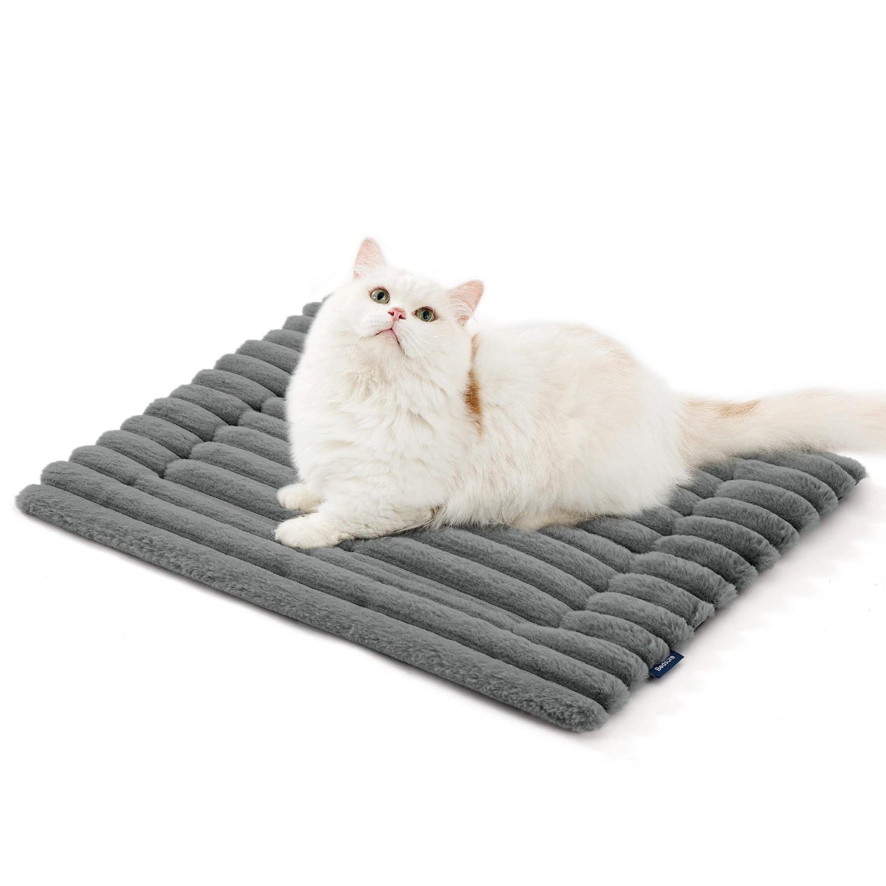 Gray faux rabbit fur pet mat with ribbed surface, featuring a white cat lying down.