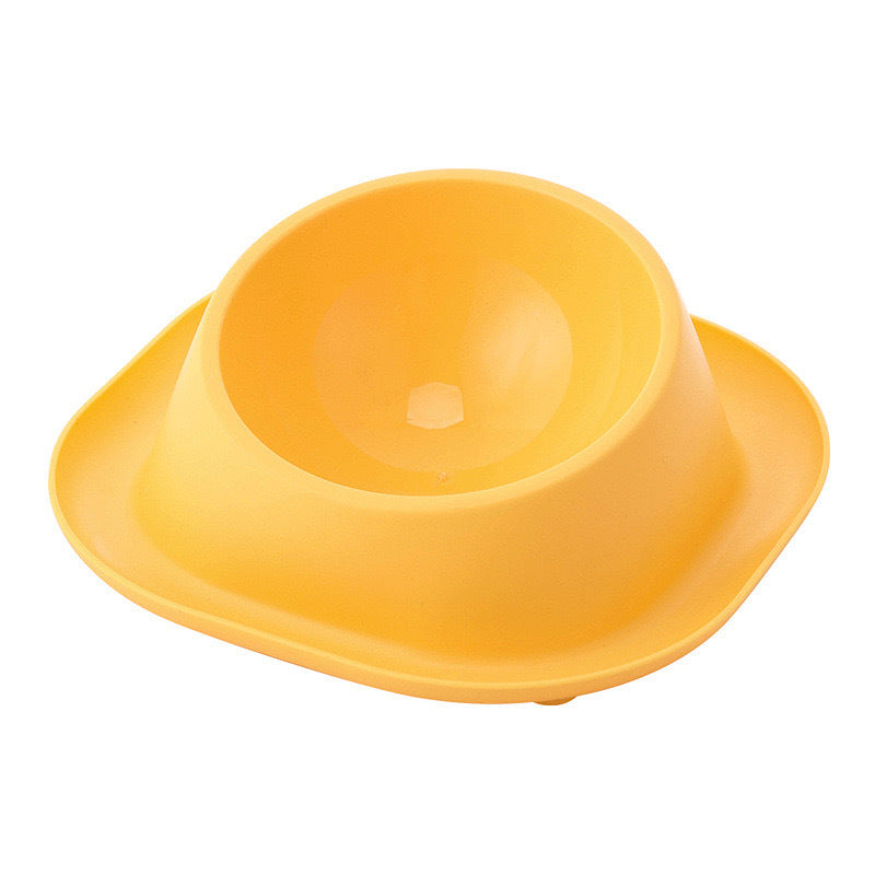Yellow tilted cat food bowl with molded inner dish