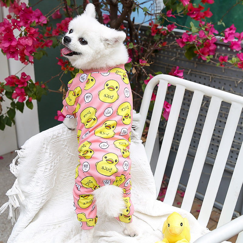 White dog wearing pink duck-pattern four-legged pet outfit with long sleeves
