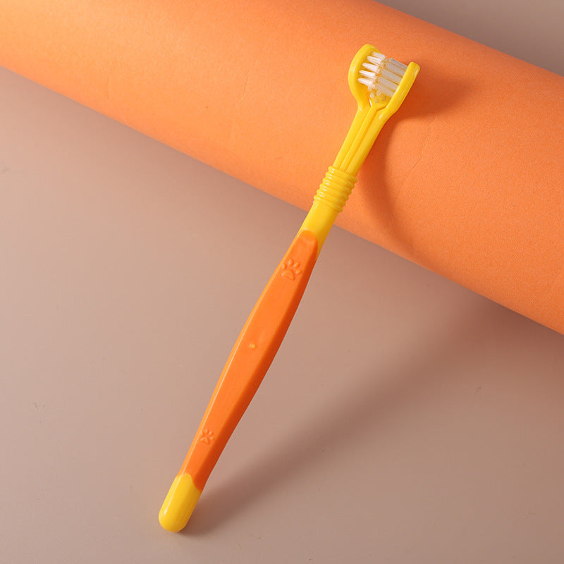 Yellow three-sided pet toothbrush with white base and bristled head