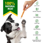 Dog chew rawhide stick, hand holding an orange-brown stick beside a dog