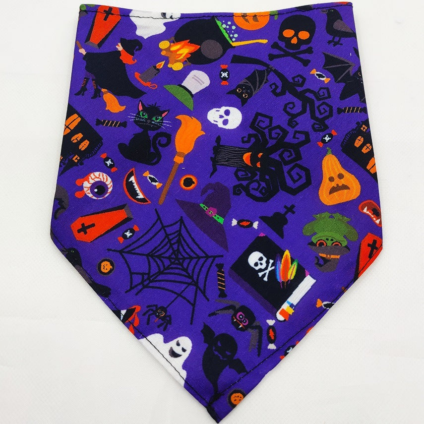 Purple pet triangle bandana with mixed Halloween graphics like bats, bones, and eyes