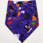 Purple pet triangle bandana with mixed Halloween graphics like bats, bones, and eyes
