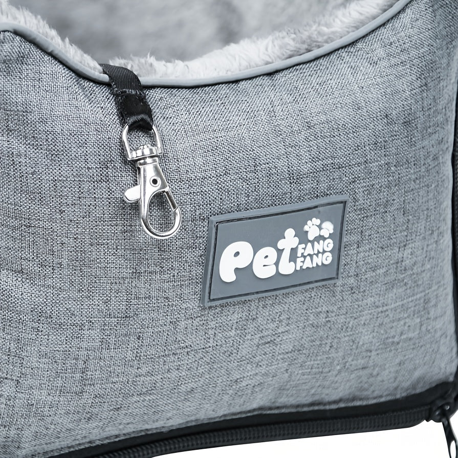 Grey pet car seat close-up with logo patch, zipper, and metal clip on strap