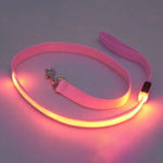 Adjustable pet car seat belt with pink strap and glowing safety edge light