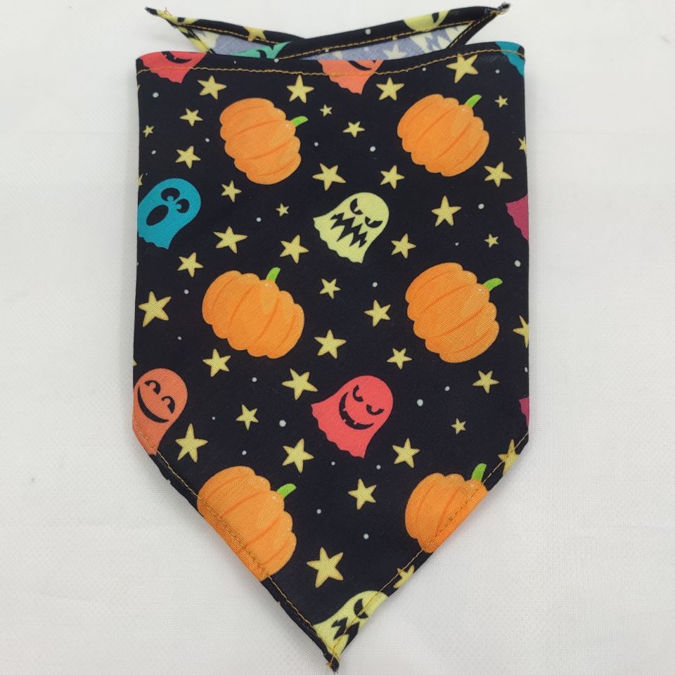 Pet triangle bandana with dark navy fabric, orange pumpkins, green accents, and yellow star dots