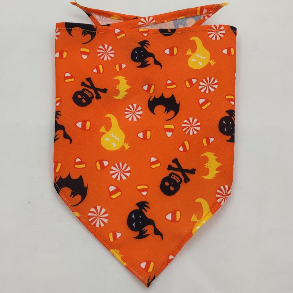 Orange pet triangle bandana with black cats, skulls, and Halloween candy icons