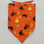 Orange pet triangle bandana with black cats, skulls, and Halloween candy icons