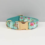 Teal floral dog collar with gold rectangular buckle and D-ring, bowtie details