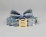 Blue plaid bow tie dog collar with gold ID nameplate reading “VIVI”