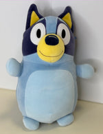 Light blue plush cuddler with yellow muzzle, big ears, and embroidered smiling face