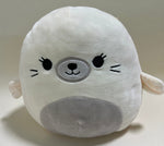 Large squishy plush pet toy, white seal with gray snout and stitched smile.