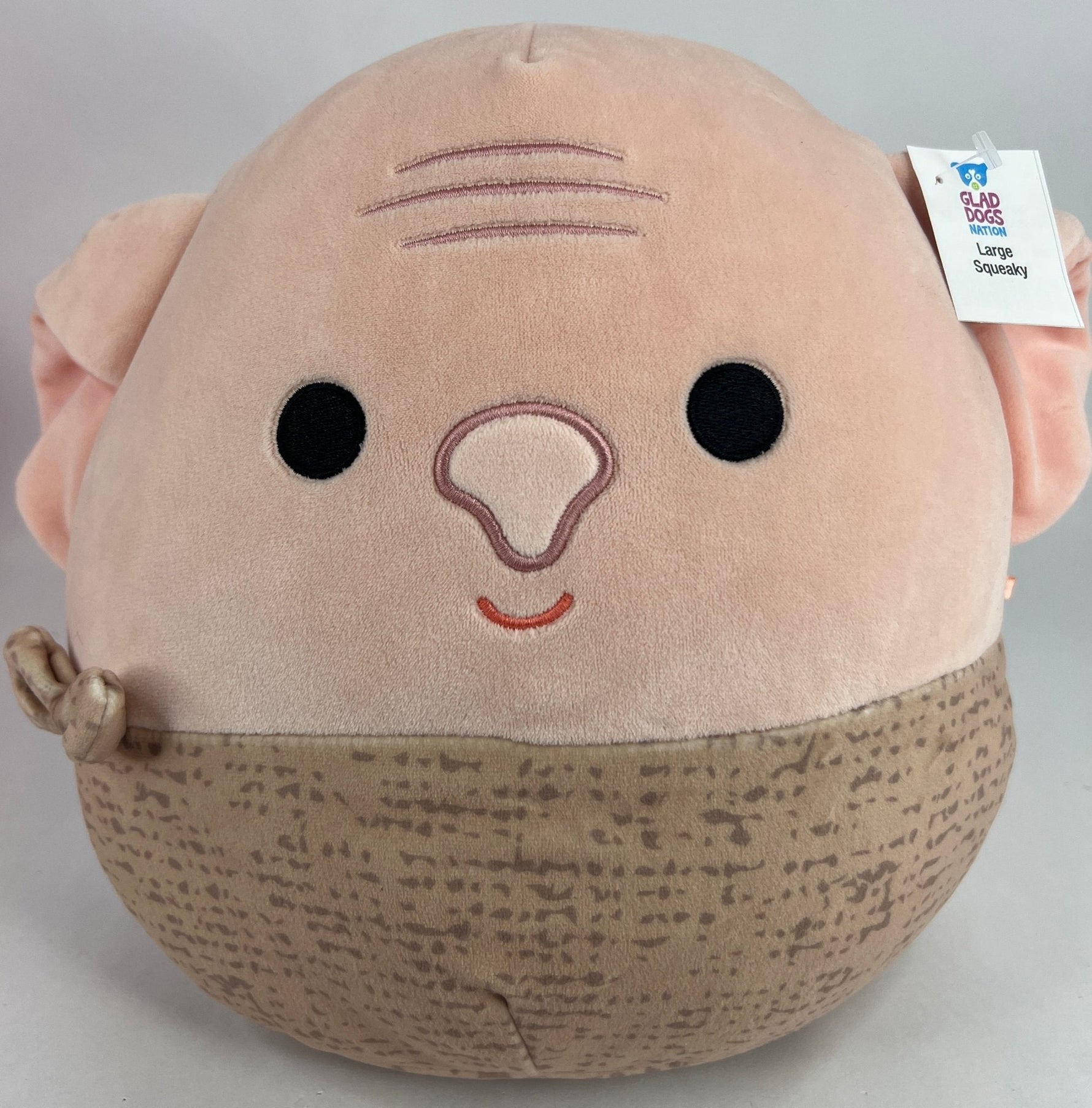 Large squishy plush pet toy, tan face with whisker lines and speckled beige body