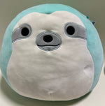 Turquoise-and-white plush seal with round black eyes and gray snout