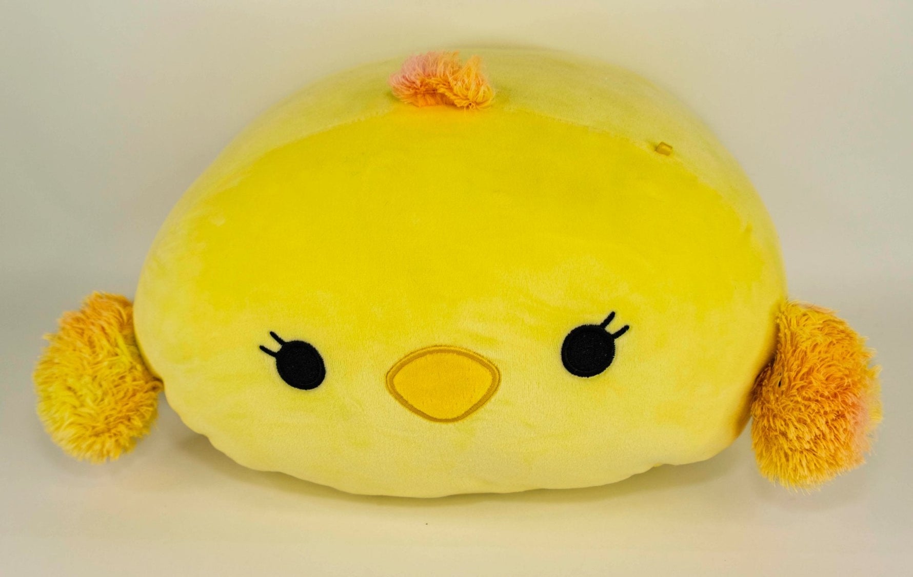 Large yellow chick plush pet toy with orange pom feet and cute embroidered face