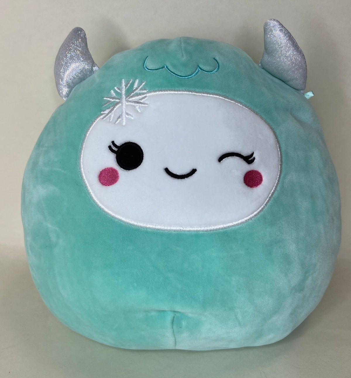 Large teal squishy narwhal plush with glitter horn and snowflake face detail