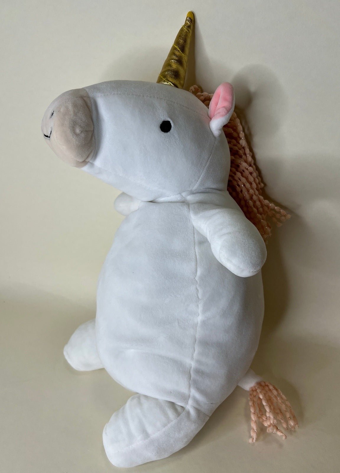 Large squishy plush pet toy, white narwhal with gold horn and soft flippers.
