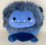 Blue shaggy plush cuddler with smiling face, rosy cheeks, and round body