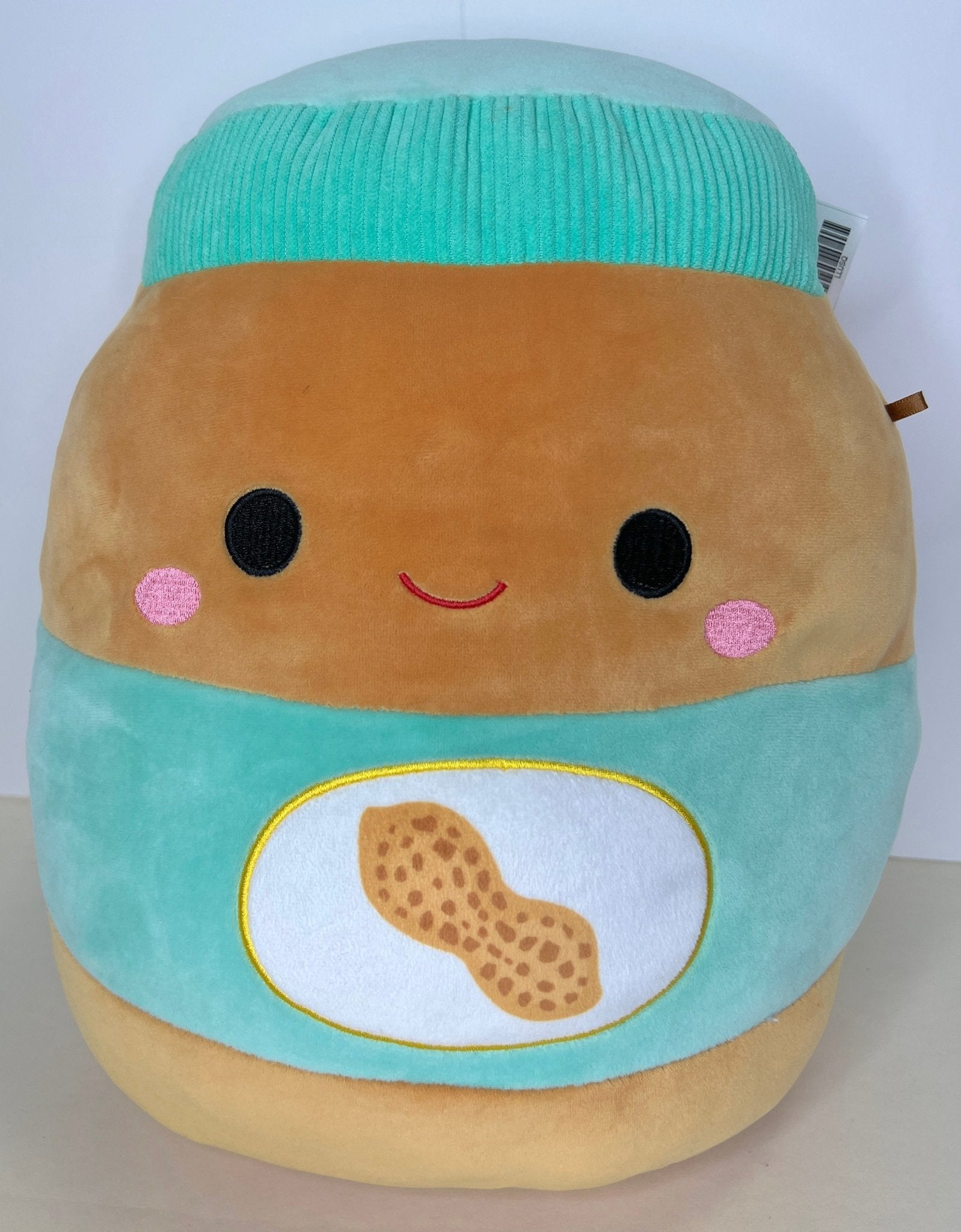 Pastel sandwich plush cuddler with teal hat and smiling face with cheese patch