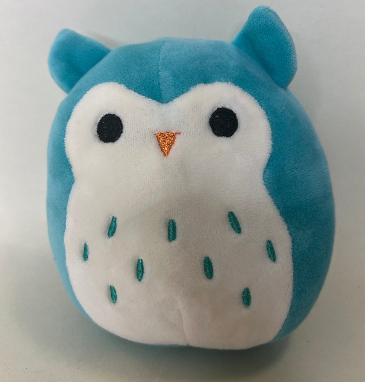 Large squishy plush pet toy, blue-and-white critter with raindrop accents and orange nose.