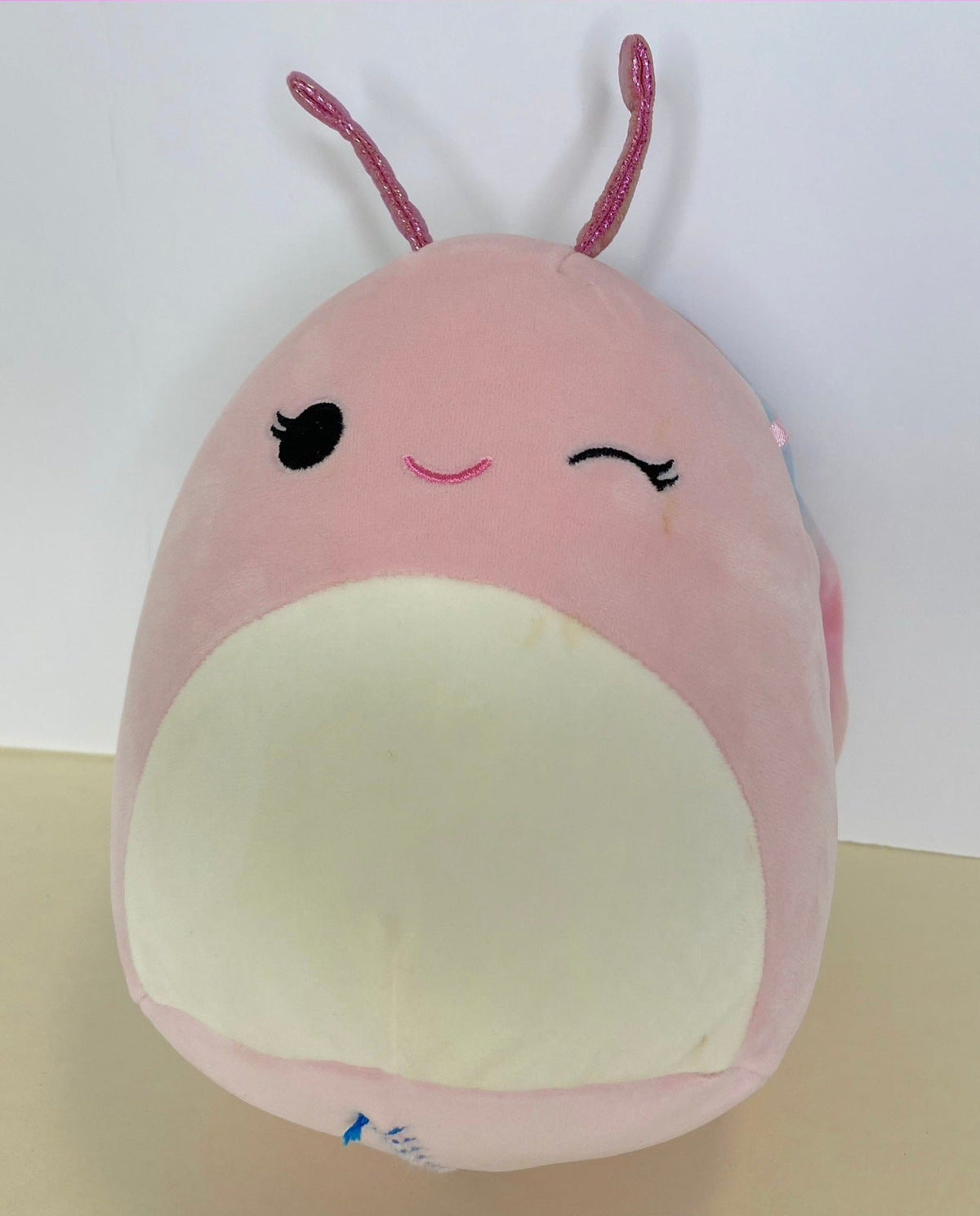 Large pink squishy plush pet toy with cream belly and long ears, smiling face