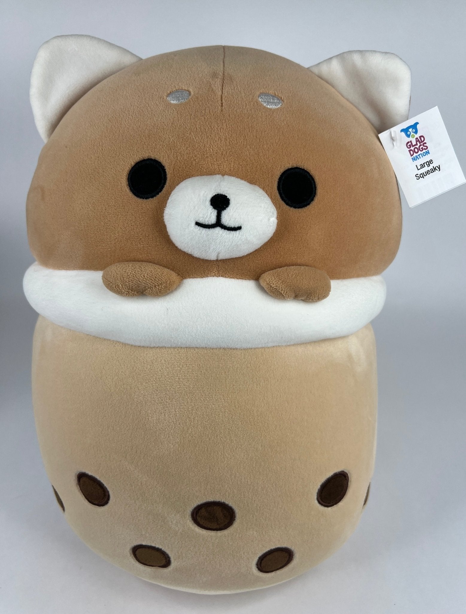 Large squishy plush pet toy, tan and cream cat-like head with paws and patterned body