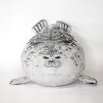 Gray-and-white seal plush cuddler with striped ears and stitched snout and whiskers