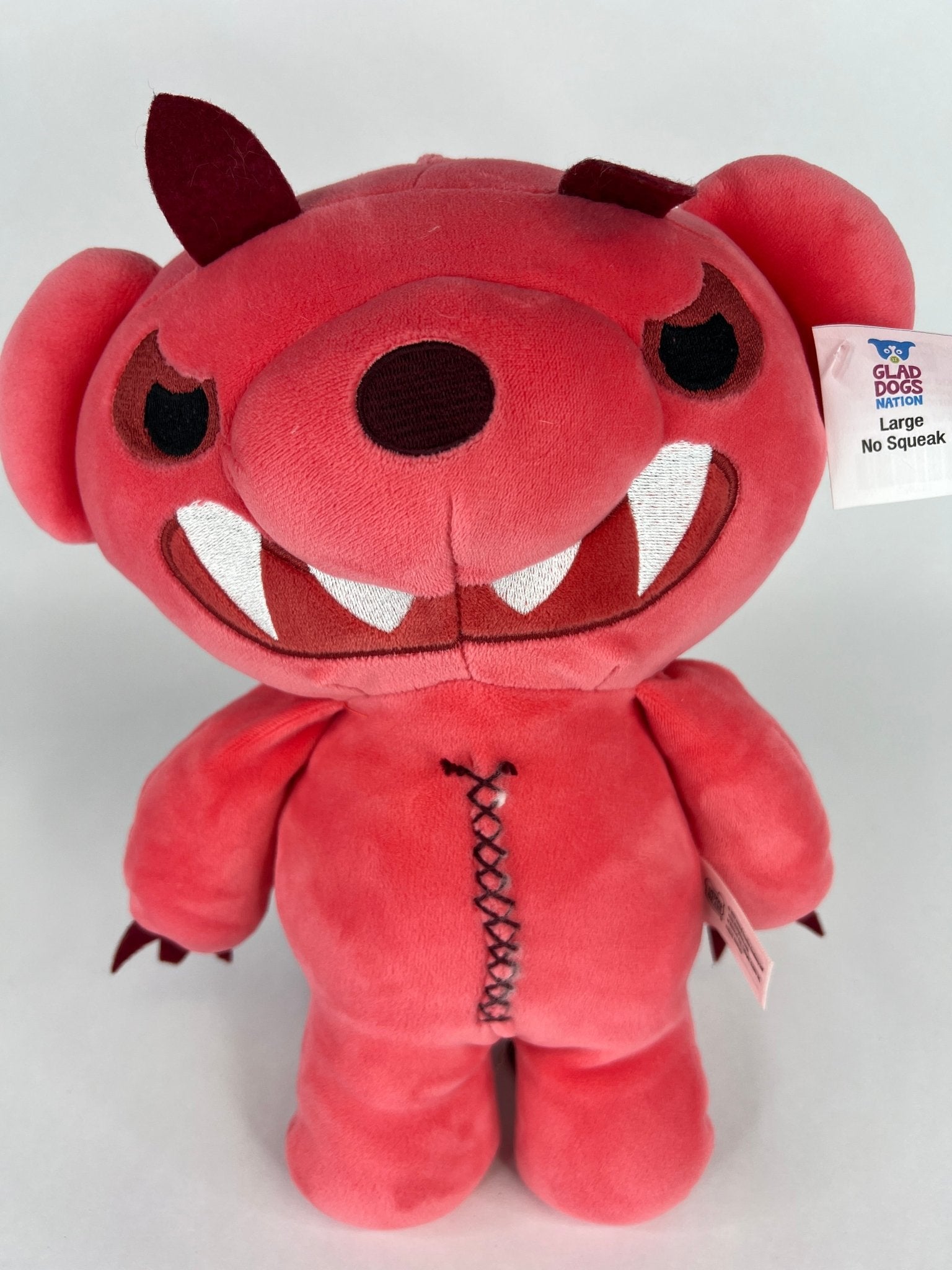 Large squishy plush pet toy, red dinosaur with big teeth smile and stitched belly
