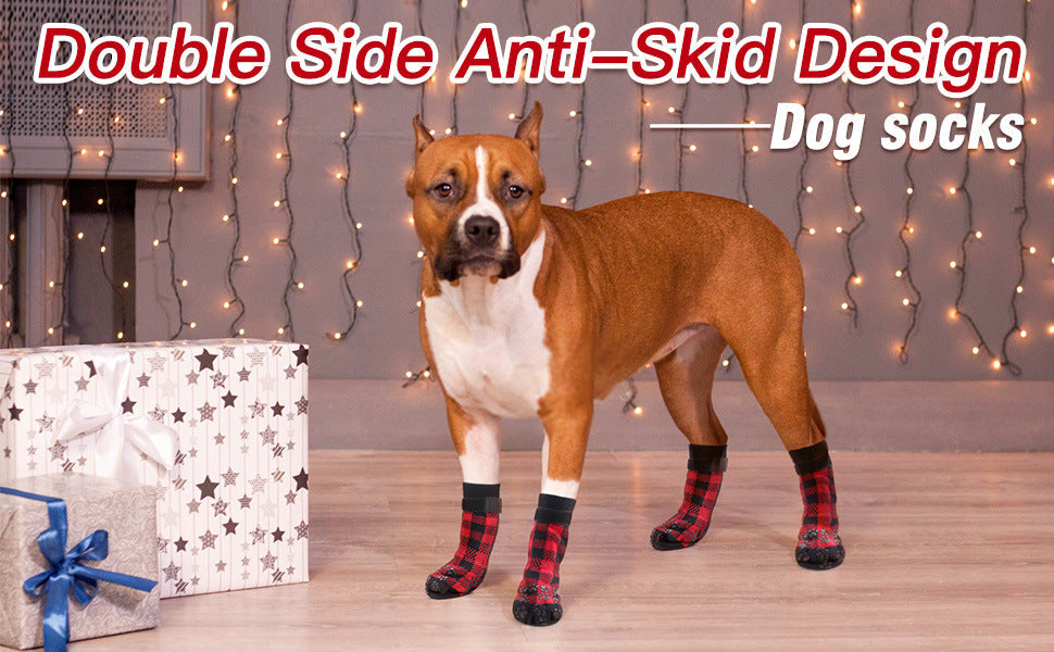 Dog wearing red and black plaid anti-skid socks with paw-print grip soles