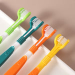 Three-sided pet toothbrushes with angled heads in green, teal, orange, and yellow