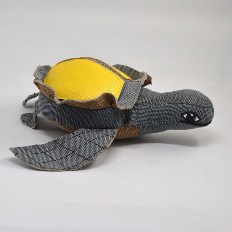Gray turtle plush toy with yellow shell and cartoon eye on one side