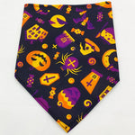 Pet triangle bandana with black base and colorful Halloween icons in orange, purple, and yellow