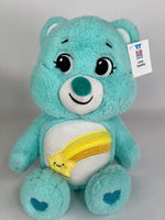 Light blue plush dog toy bear with smiling face and yellow fish belly applique.