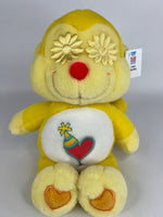 Upcycled plush dog toy, yellow bear with flower head top and heart belly patch, brand tag