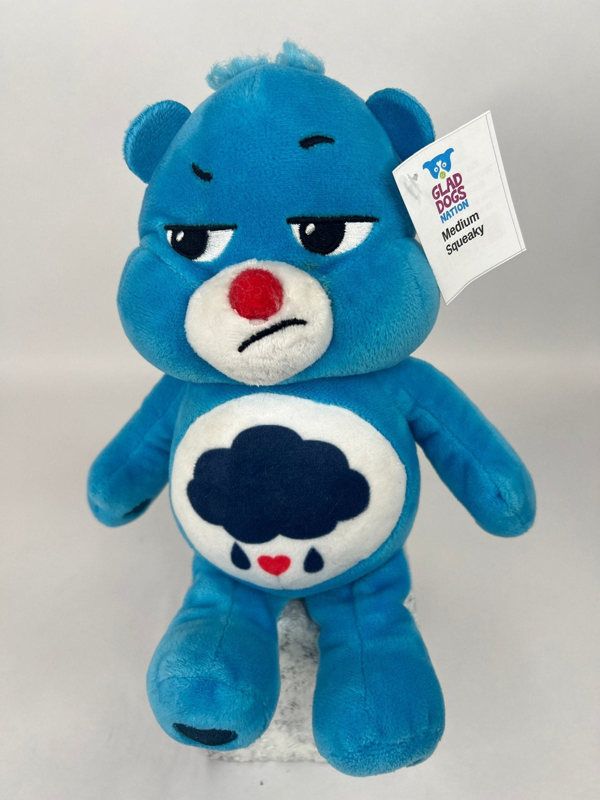 Upcycled plush dog toy, blue bear with red nose and cloud belly patch, brand tag