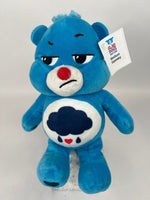 Upcycled plush dog toy, blue bear with red nose and cloud belly patch, brand tag
