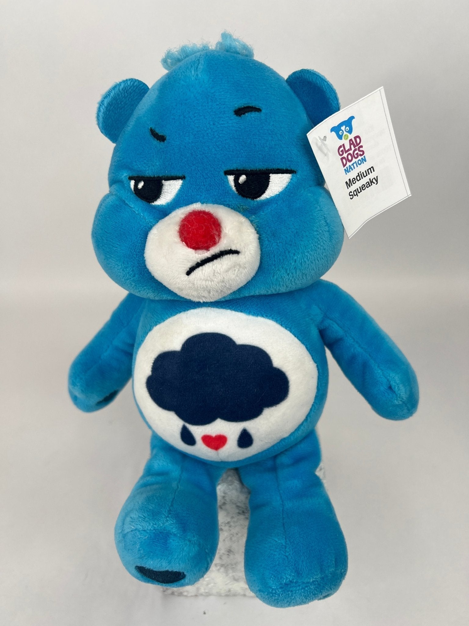 Upcycled plush dog toy, blue bear with red nose and cloud belly patch, brand tag