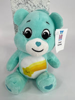 Upcycled plush dog toy, teal bear with smiling face and rainbow belly patch, brand tag